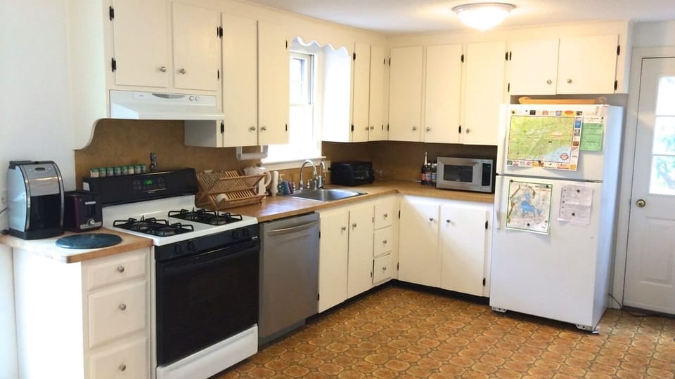 Kitchen with newer appliances, sliding doors to large deck
