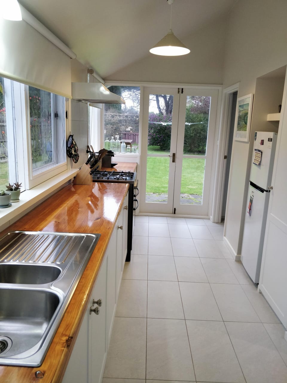 Light and Bright Galley Kitchen with direct access to the backyard.