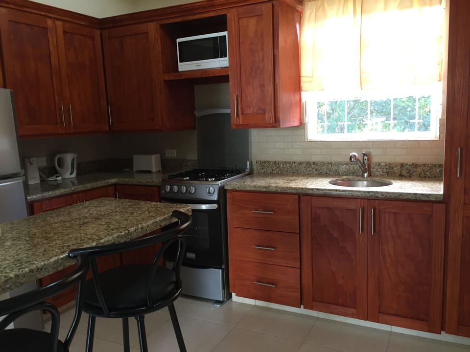 Kitchen with Granite counter top, stainless steel appliances and breakfast bar