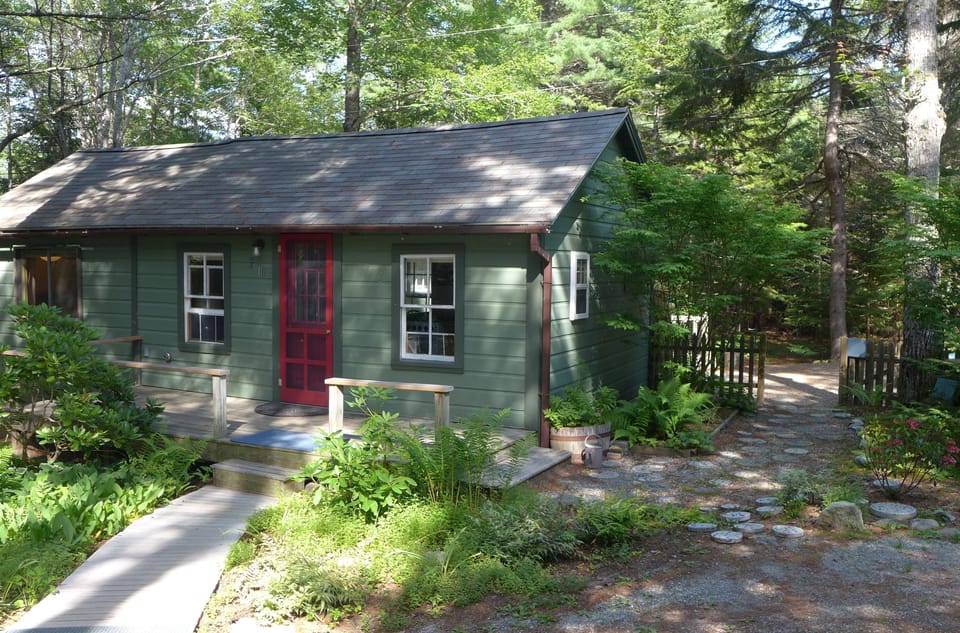Dappled shade and flower gardens add to the relaxed comfort of this cabin.