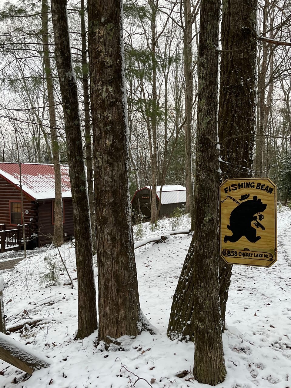 Cabin sign, view heading down the mountain road.