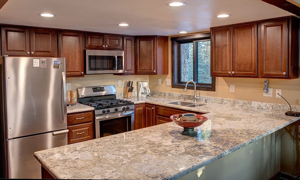 Kitchen has microwave, coffee maker, grinder, dishes some spices, pots and pans.
