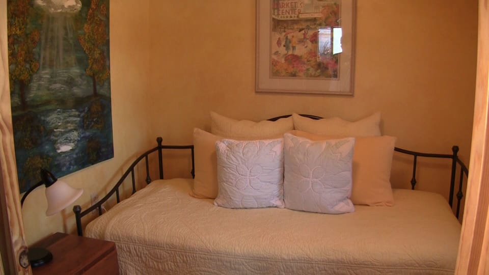 Second bedroom twin with a trundle underneath and original art adorns the walls