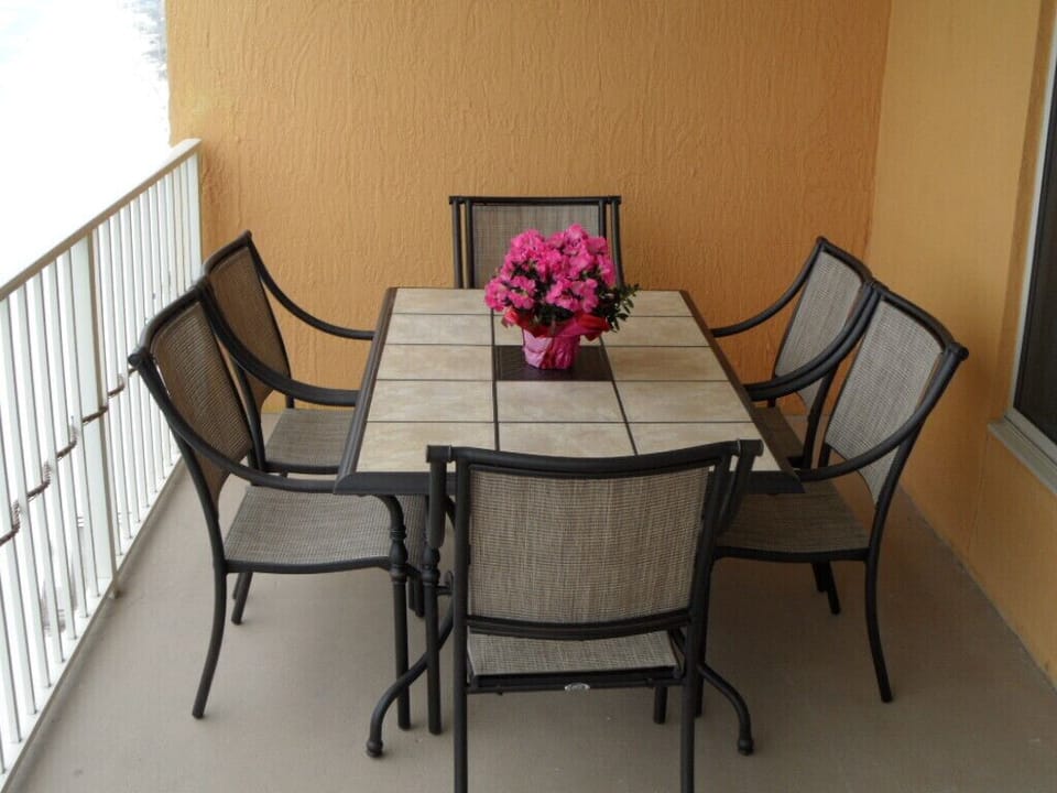 Enjoy the view while dining on the balcony, seating for 6 accommodates up to 8.