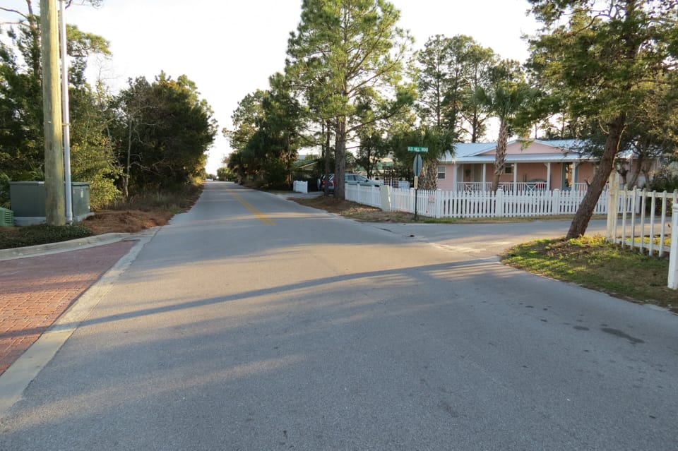 Stroll down tree-lined street to beach