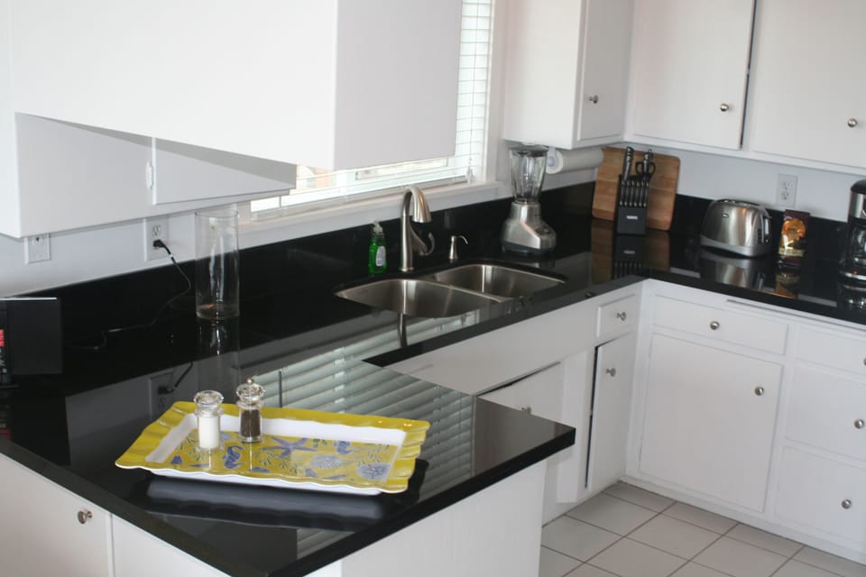 Kitchen with granite counters, stainless steel appliances and ocean views
