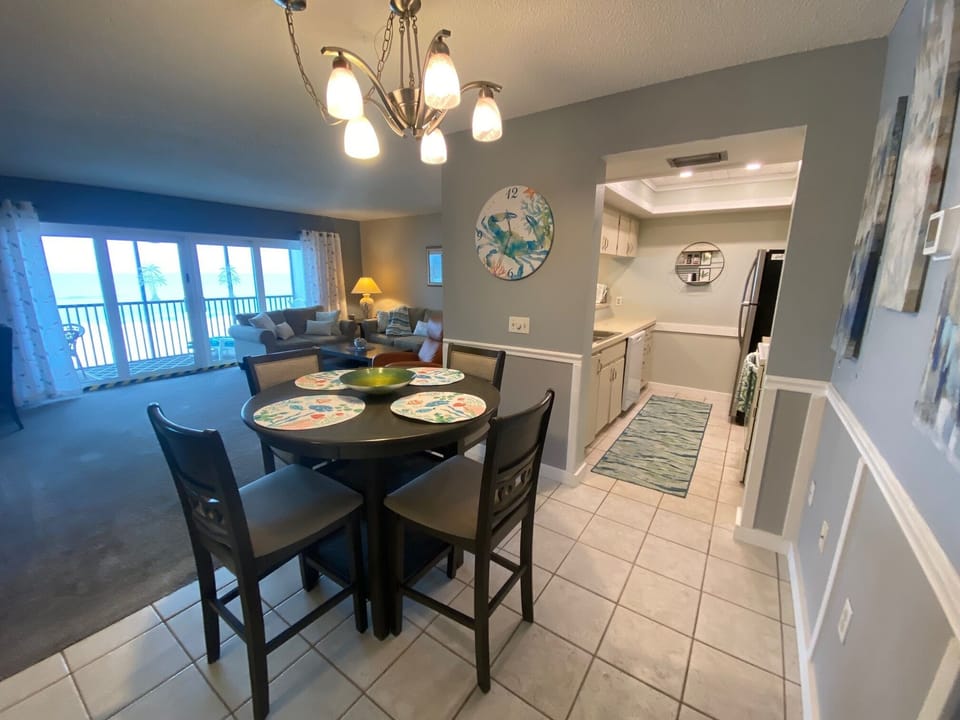 Galley kitchen fully equipped with appliances and cookware.