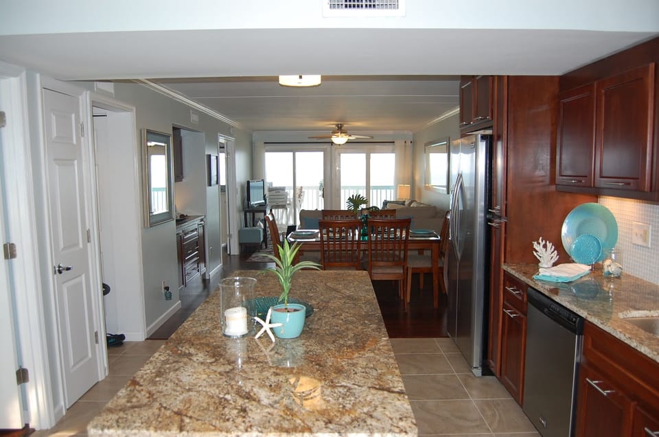 Fully Equipped Kitchen With Granite, Stainless Steel, And Island With Seating