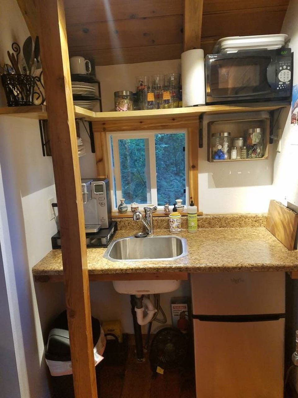 Kitchenette with microwave and small refrigerator.