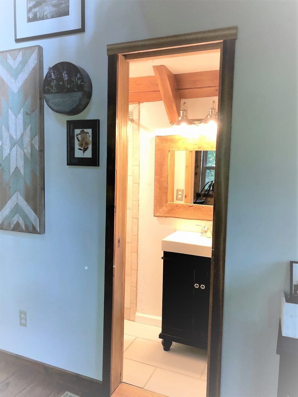 View of the bathroom from the living room with pocket door open.