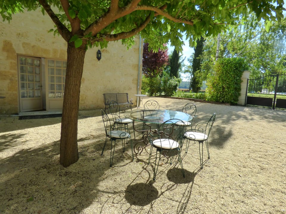Cottage courtyard with front door and outdoor dining area