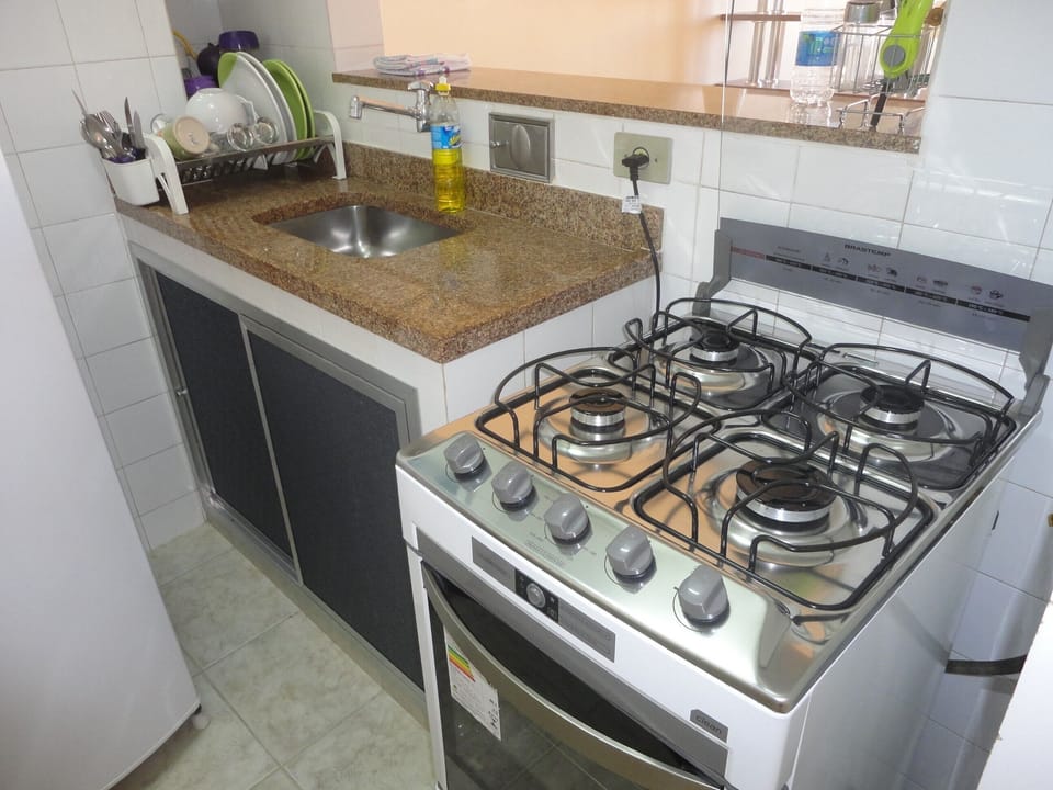 Coffee/tea maker, fridge, stovetop, dining table