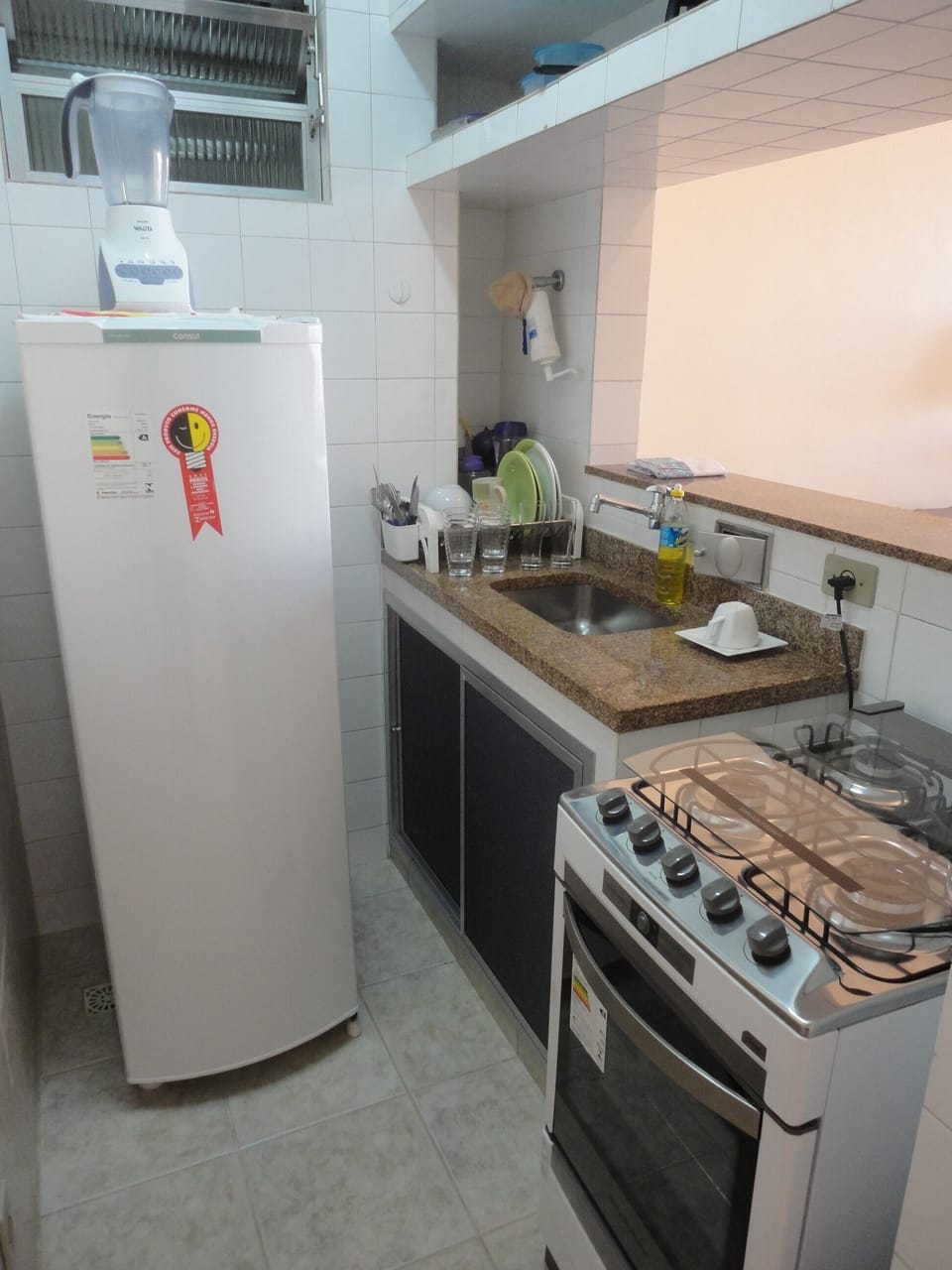 Coffee/tea maker, fridge, stovetop, dining table
