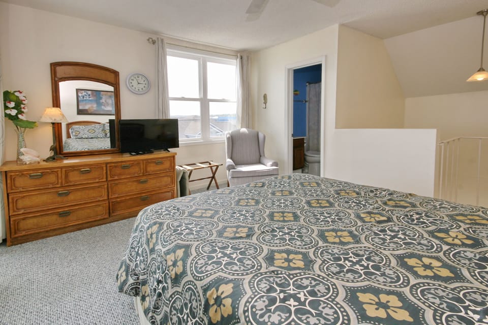 Upstairs (loft) bedroom, with private balcony, TV,  and bathroom