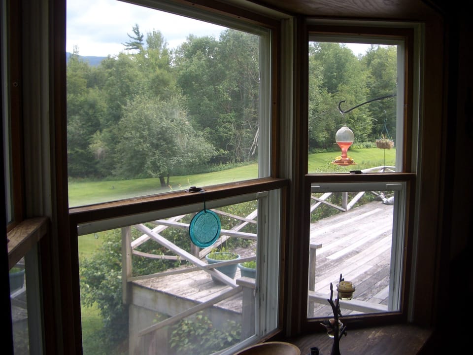 View of deck through bay window, dining area