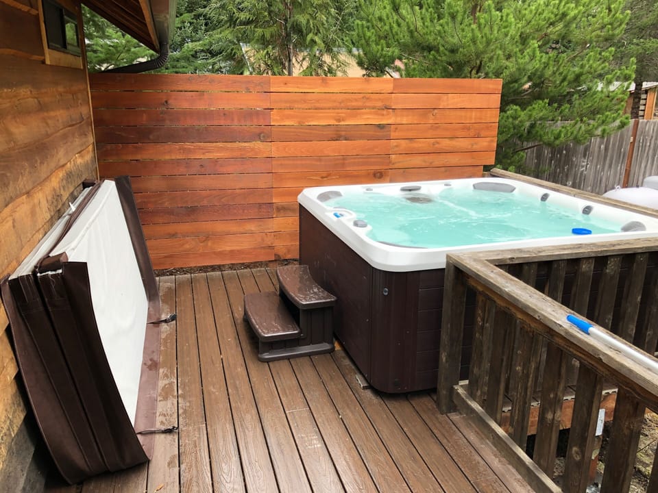 6 person  jakuzzi on back deck overlooking private fenced yard & fire pit. 
