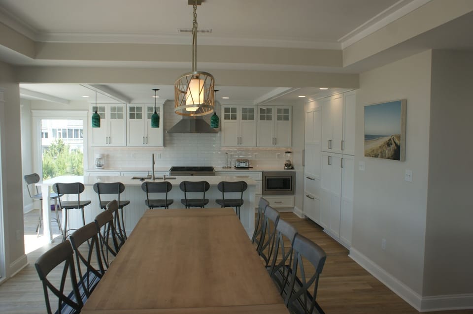 Spacious kitchen with Subzero refrigerator and designer gas stove.