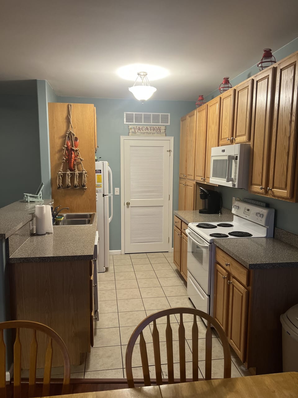Kitchen with laundry room behind door. Kitchen fully stocked for your needs!