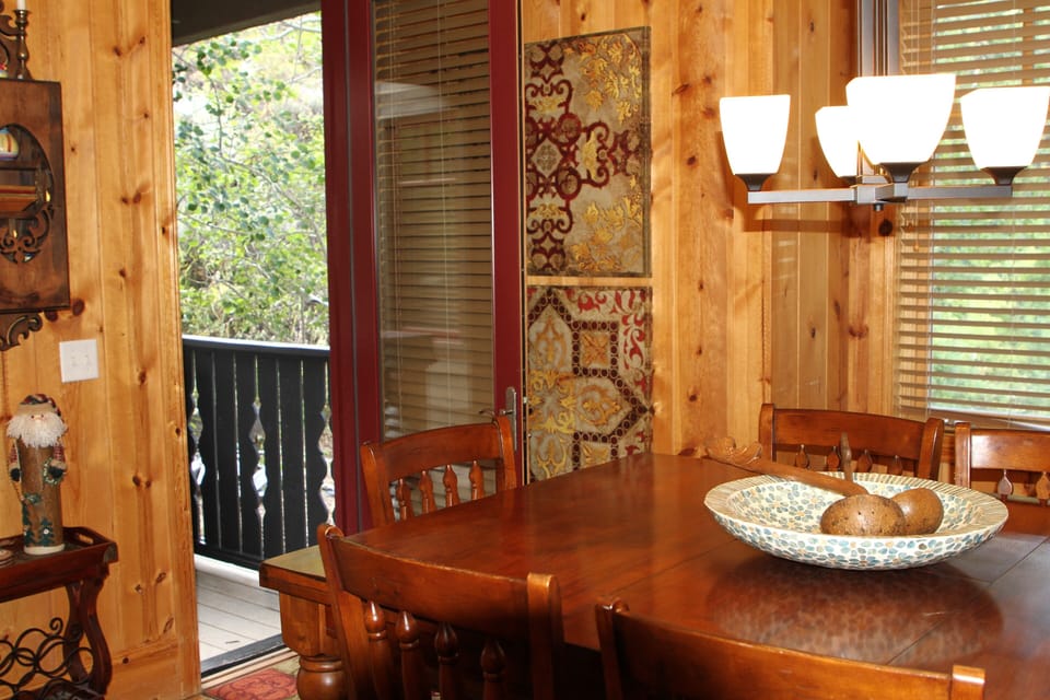 Door from dining room to deck and secluded hot tub.