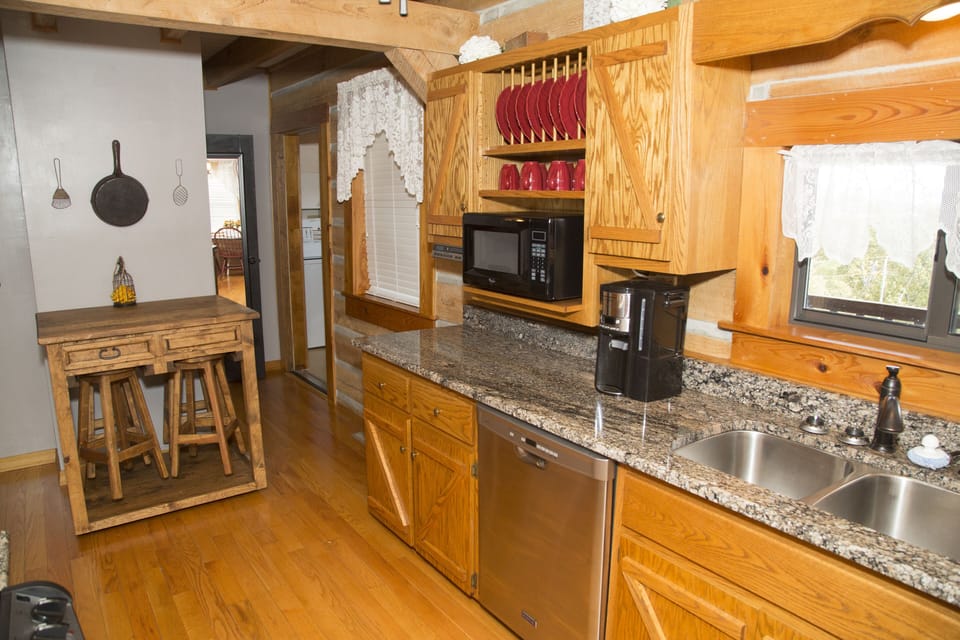 New granite with a deep sink makes the kitchen very functional. 