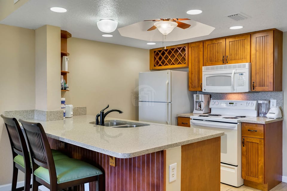 Fully equipped kitchen with refrigerator, microwave, coffee maker and more.