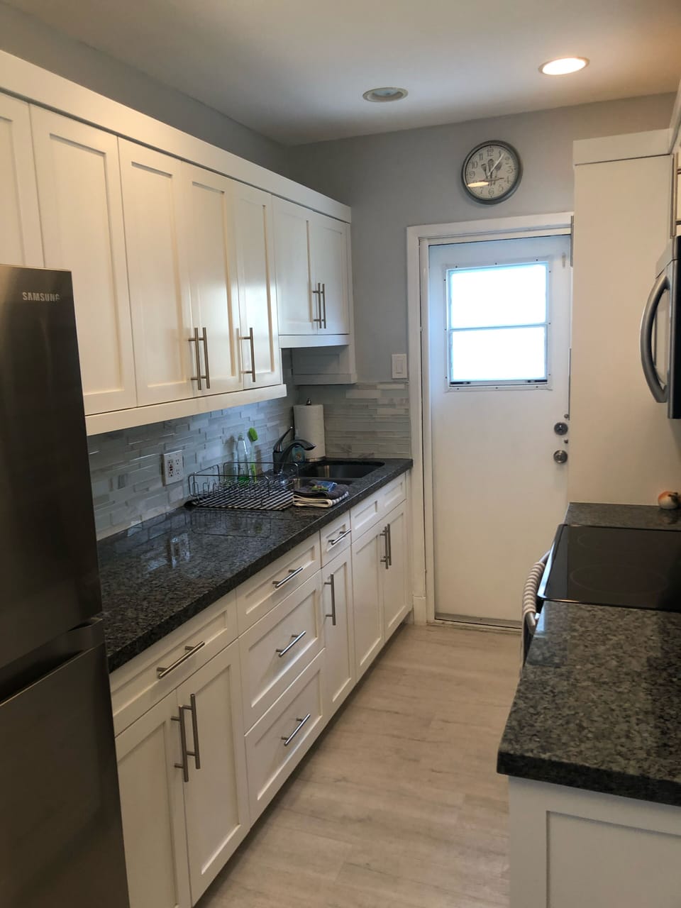 well equipped galley kitchen and back door to laundry and outdoor shower 