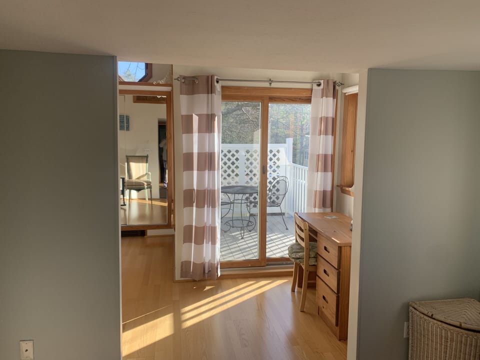 Small deck and sunroom off of the primary bedroom