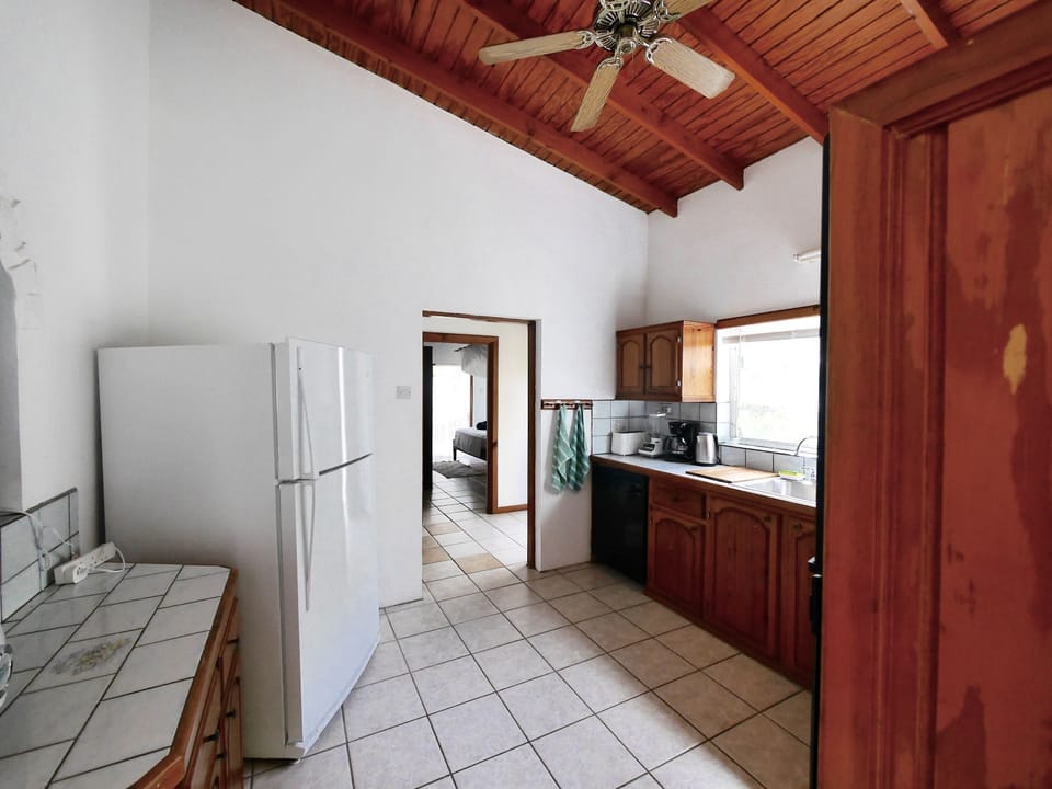 coming from back terrace to kitchen with a view of bedroom 1