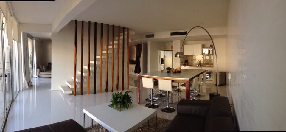 Dining room, Sofas, and Kitchen. Notice stairs. 