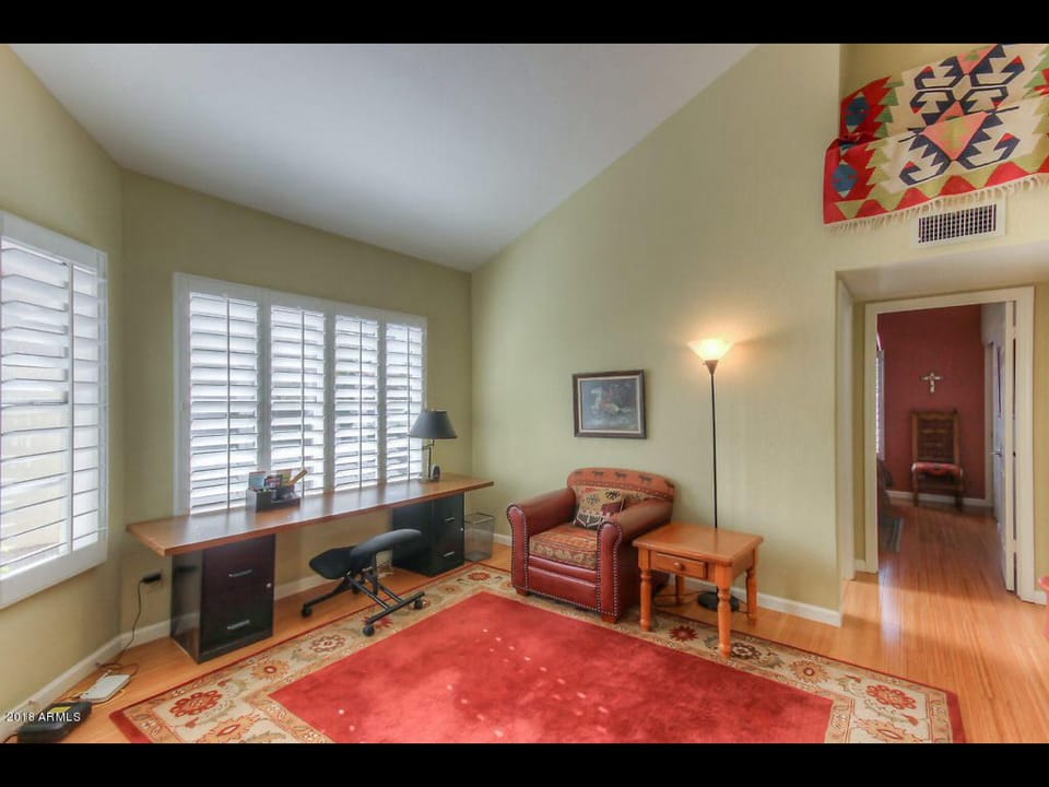 Comfortable den with office work area and tv