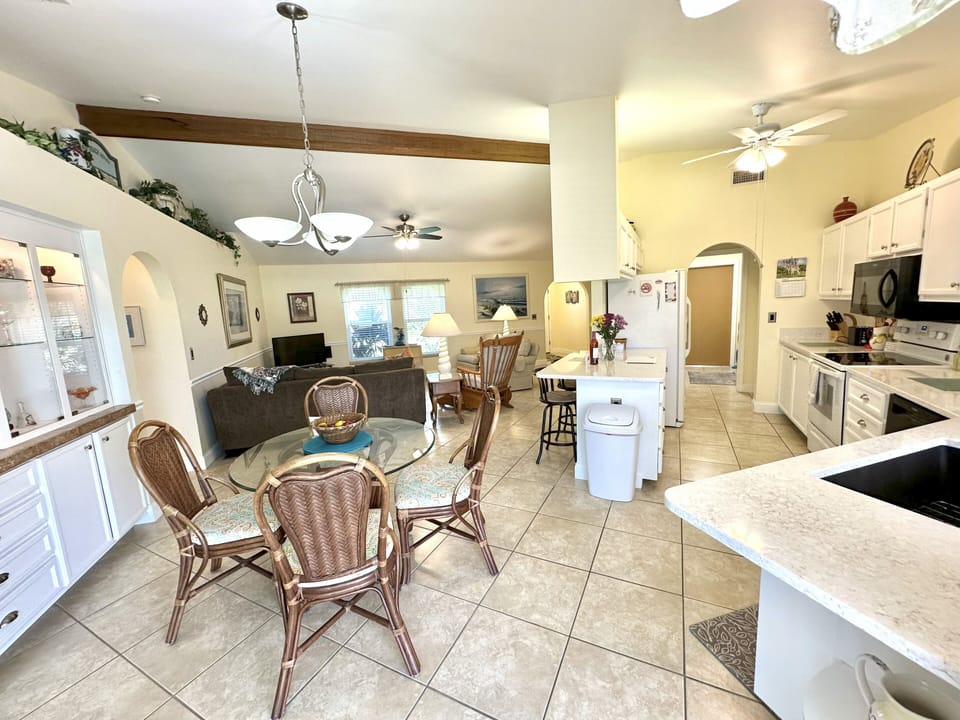 Open floor plan with easy access to kitchen, dining & living room and pool area