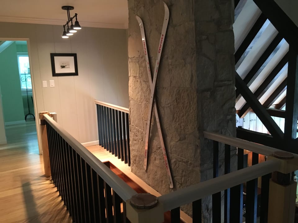 Staircase behind Stone Fireplace to second floor