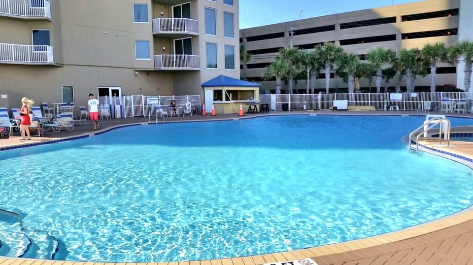 The east side pool with Tiki bat and attached 5-story parking garage 