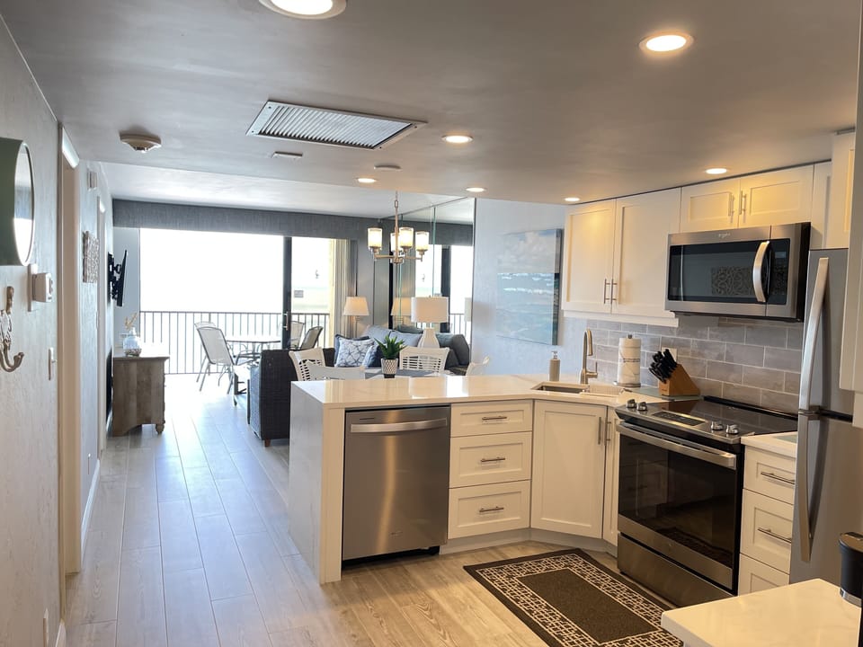OPEN LIVING AREA - NEW TILE THROUGHOUT THE UNIT