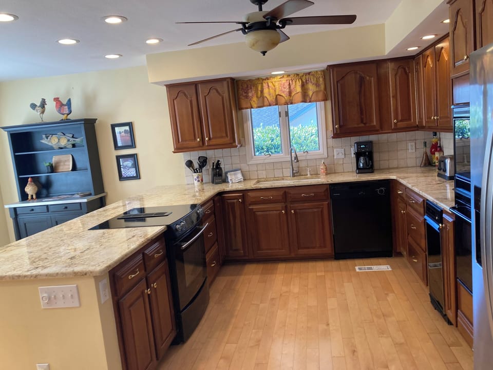 Kitchen with granite counters, two ovens, and appliances.