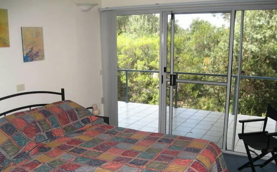 Main bedroom with balcony looking out into bush.