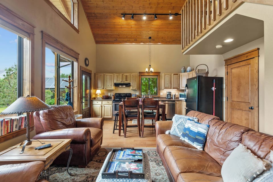 Open concept living and dining area with expansive windows facing west
