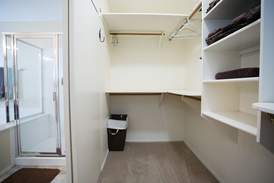 Walk in closet with plenty of storage for his and her wardrobe