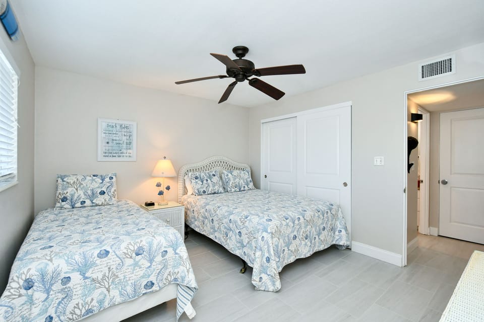 2nd Bedroom with queen plus twin-size beds, HDTV, large window overlooking bay and boat docks