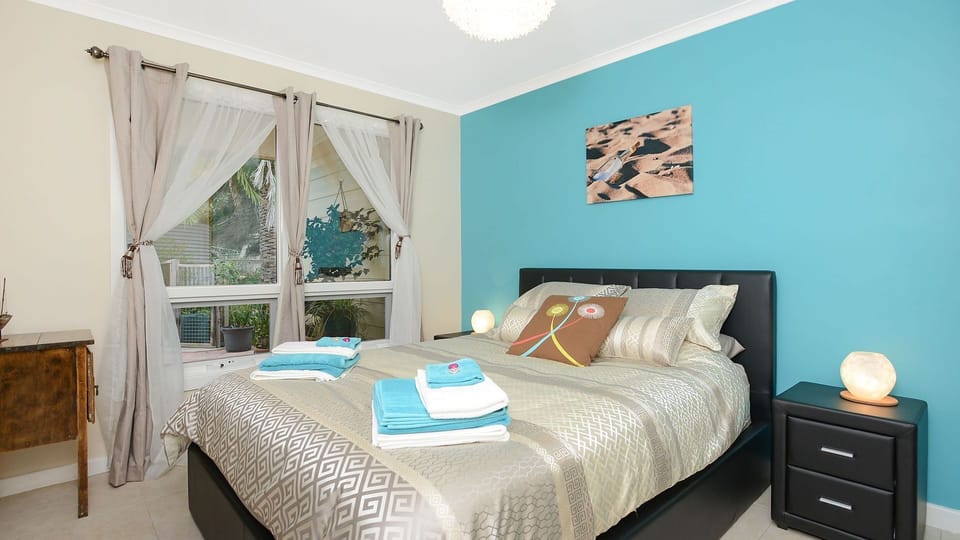 Queen bed 1 with built in robe overlooks courtyard garden