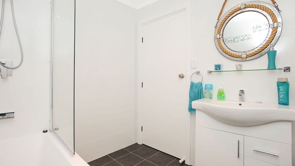 bathroom with shower over full bath