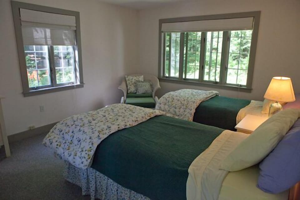 Guest bedroom with two twin beds, large closet and dresser.