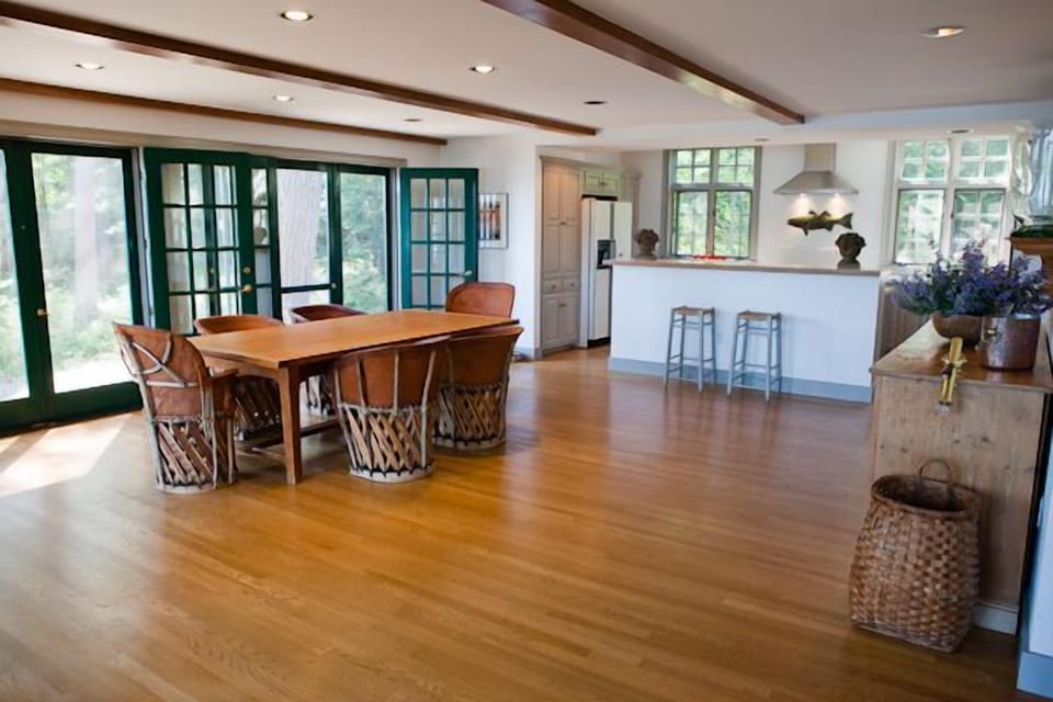 View of dining area and kitchen breakfast bar with views of the lake.