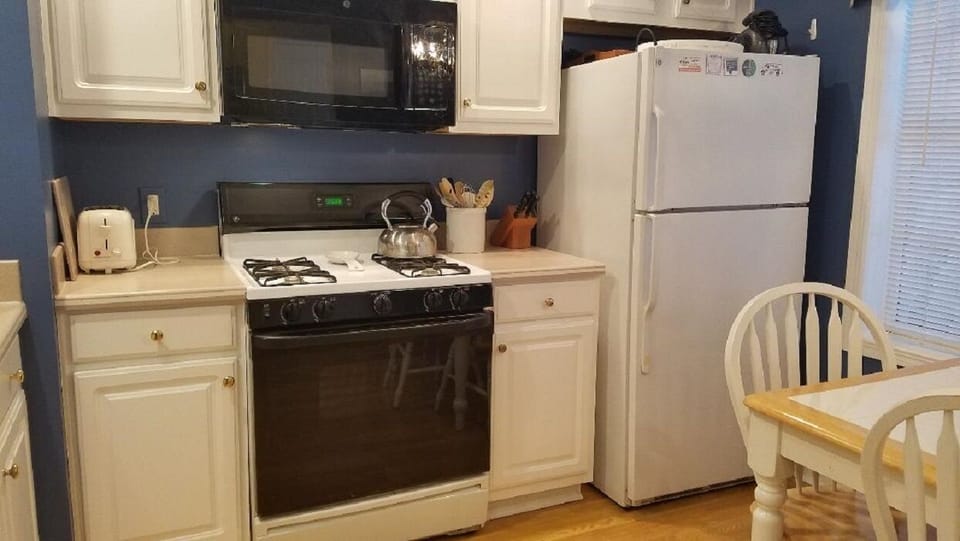 Kitchen has a complete cooking set of pots and pans and glass baking dishes,
