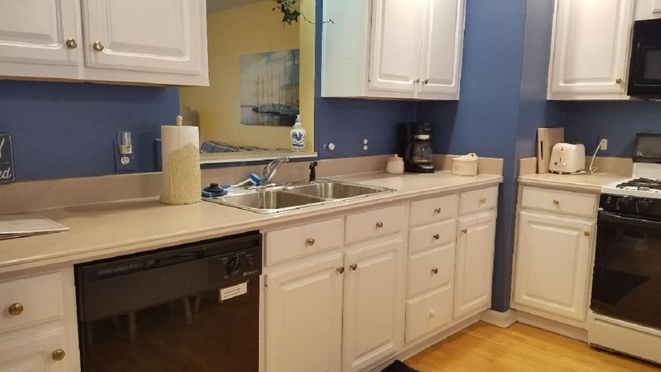 Kitchen has opening above the sink to overlook the Living Room.