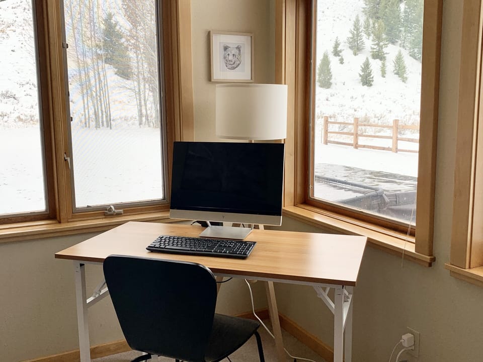 Two folding desks and monitors for remote work flexibility.