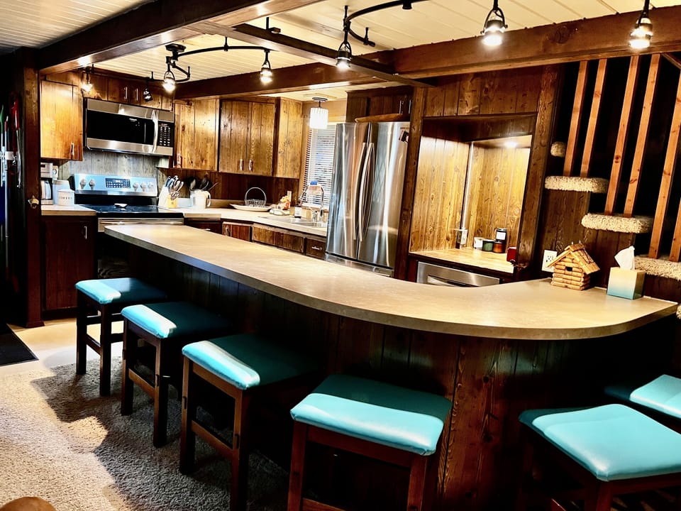 Kitchen with eating bar and seating for six.