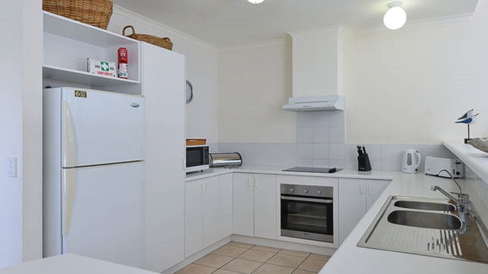 Full kitchen with microwave, oven, cooktop, dishwasher, pantry cupboard