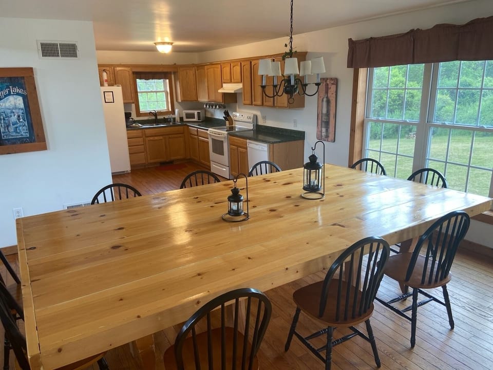 Dining area with open views into both the kitchen and living room.