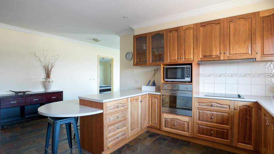 Ample bench space, cupboards full of utensils and cooking equipment.
